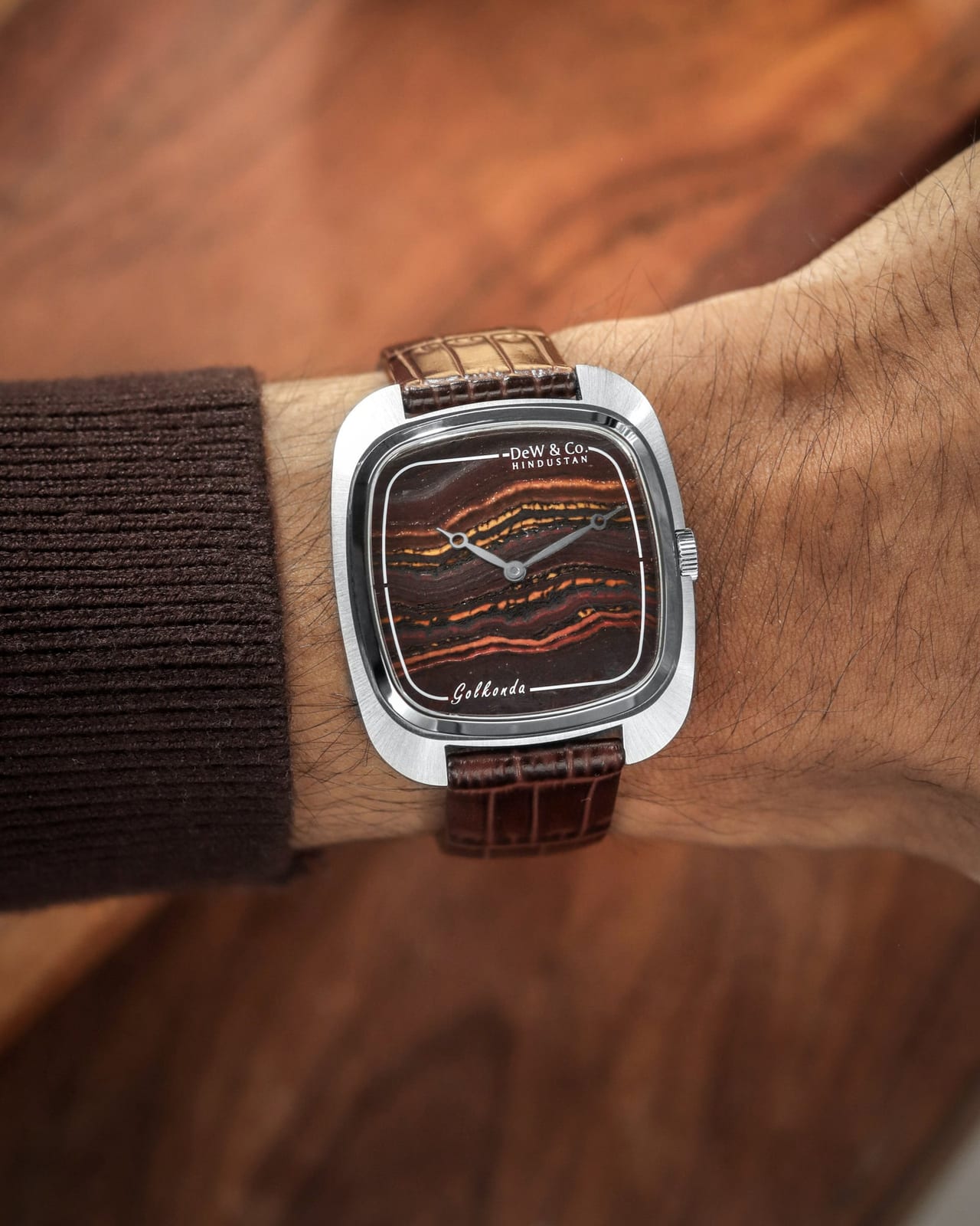 The Golkonda Tiger Ferrum on a wrist, its 35.5mm steel cushion case and tiger iron dial sitting well inside the wrist on a brown leather strap