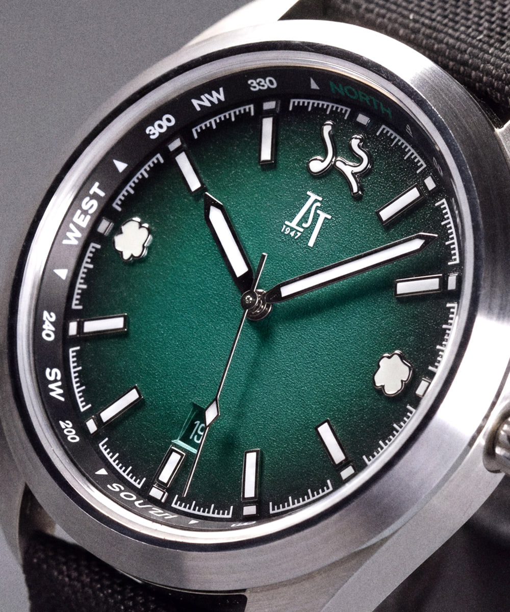 Close-up of the IST 1947 Vanya Kaziranga Gorh: teal green fumé dial with an Assamese numeral at 12 and rhino hoof-print markers at 3 and 9